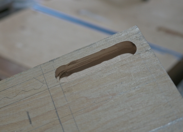 a routed slot in the maple where each subsequent layer has different bumps.
